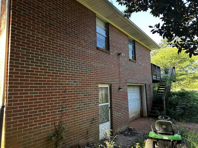 Side elevation and basement garage entry