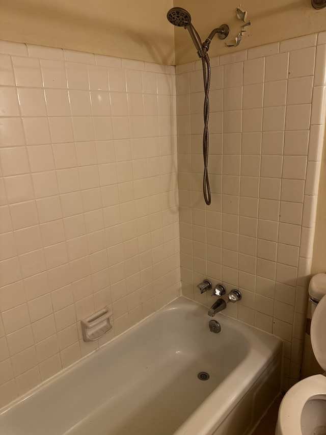 Full bath with tub and tile surround
